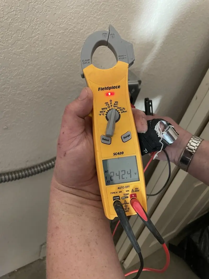 Voltage testing with clamp meter during Outlet Installation in Winterset